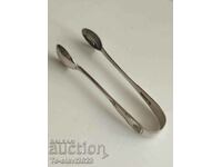Old silver-plated sugar tongs, ice