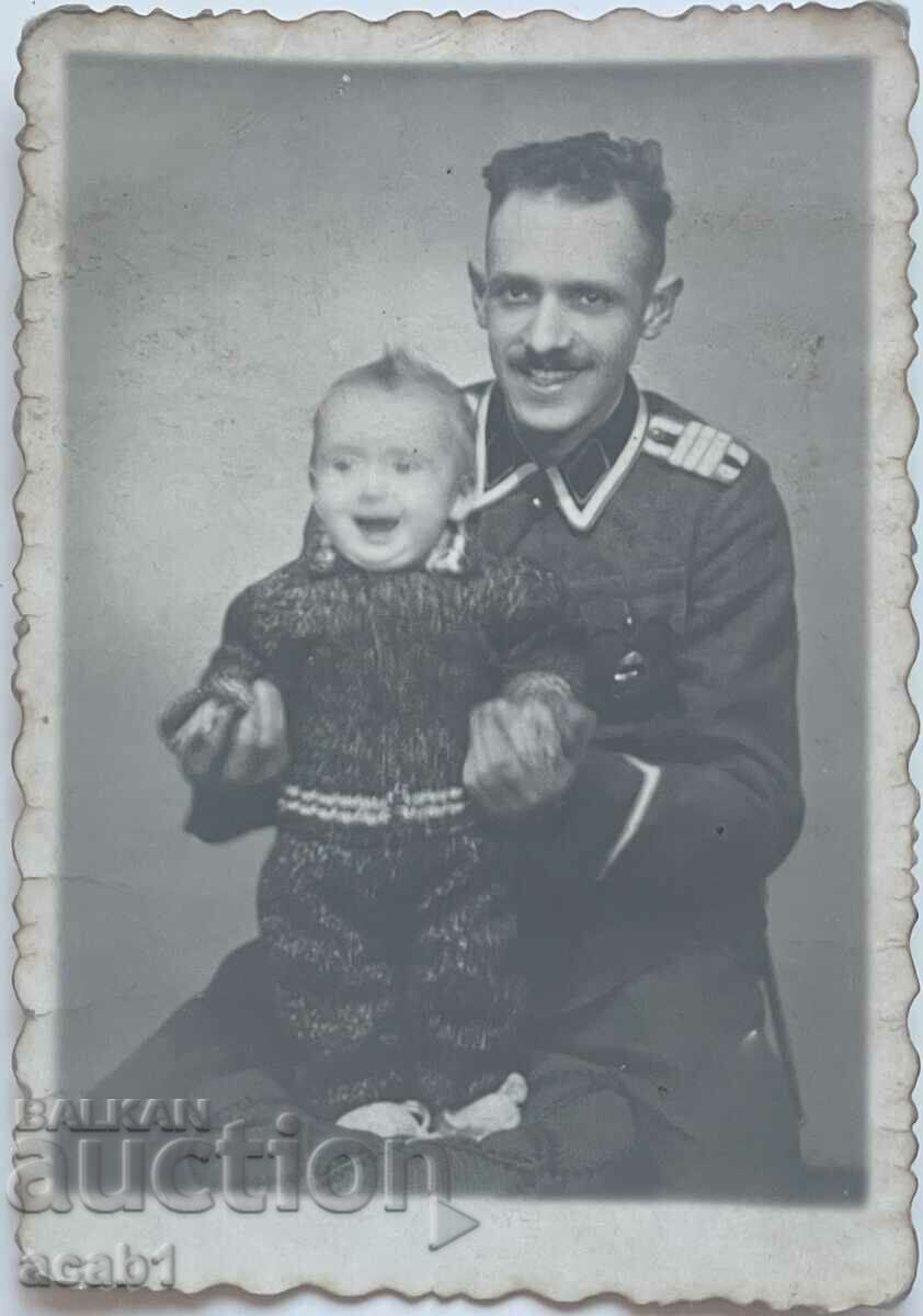 A soldier with a prize and a child