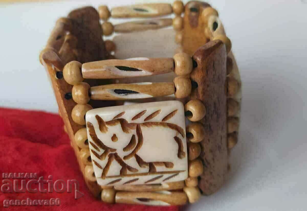 Wide bone bracelet with elephant carving