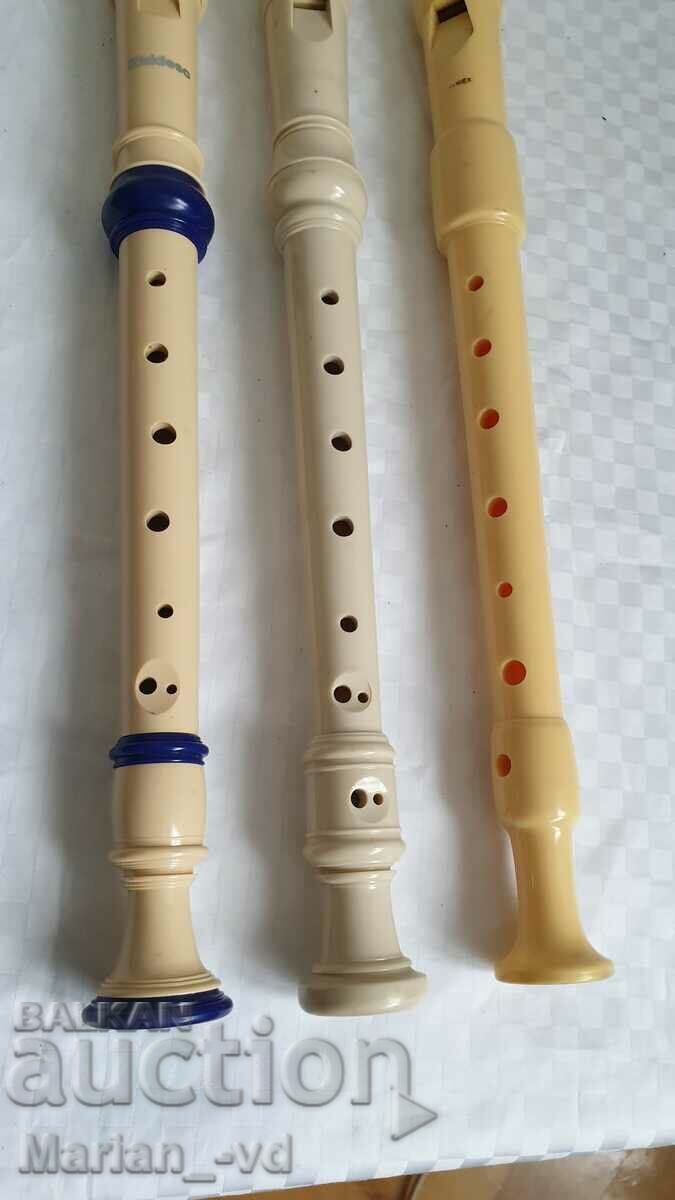 Auction Three plastic flutes Auction Three plastic flutes