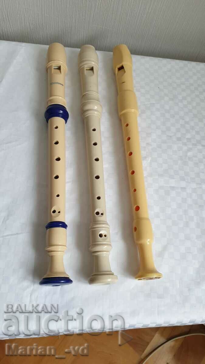 Three plastic flutes