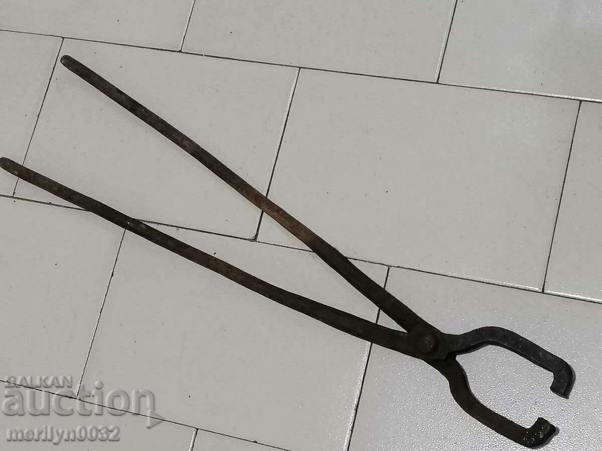 Old blacksmith's tongs, wrought iron, tile tool