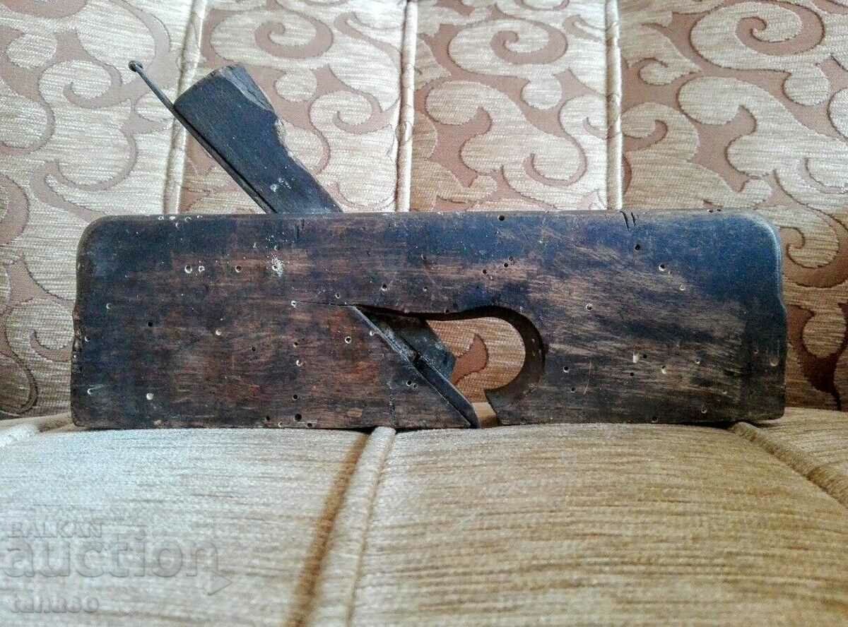 Old woodworking planer with knife