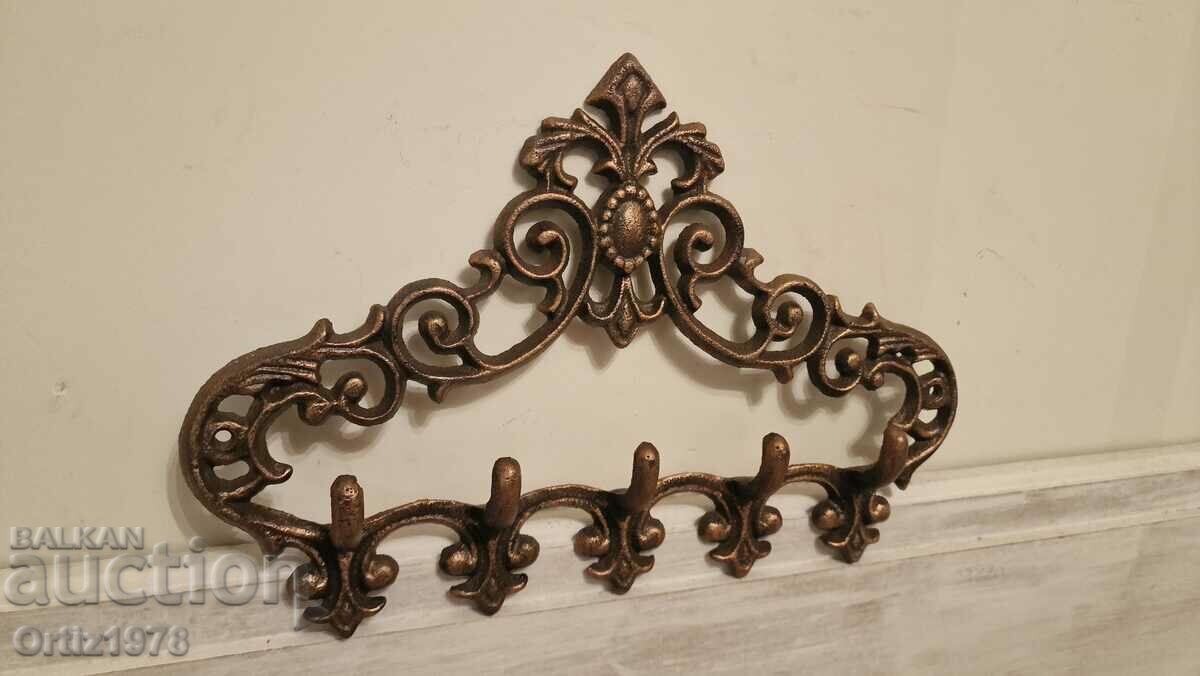 Exquisite cast iron hanger with Baroque elements.