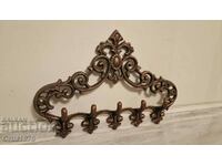 Exquisite cast iron hanger with Baroque elements.