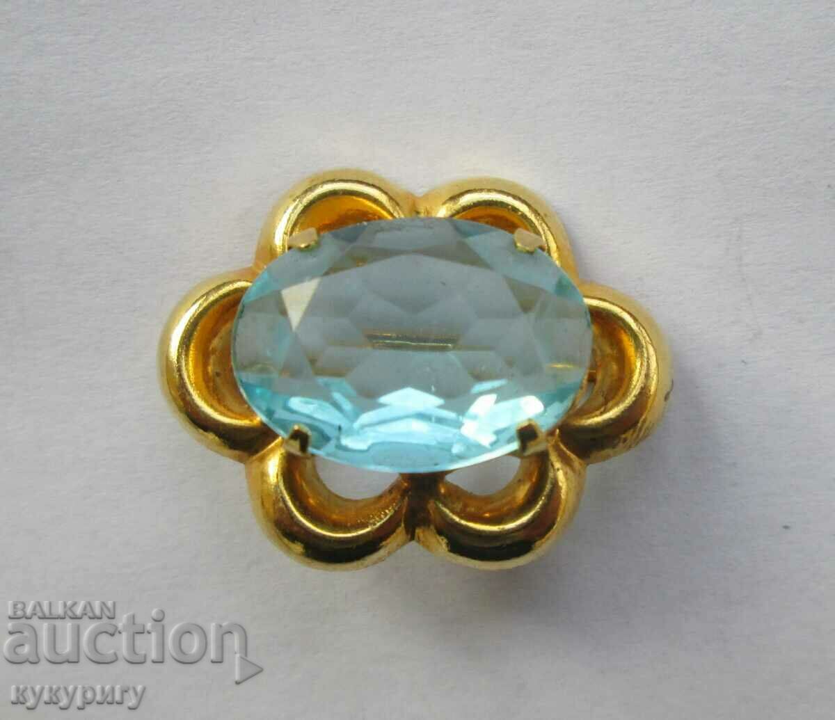 A beautiful old elegant lady's brooch with a light blue stone