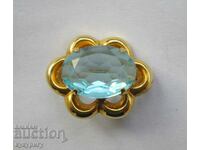 A beautiful old elegant lady's brooch with a light blue stone