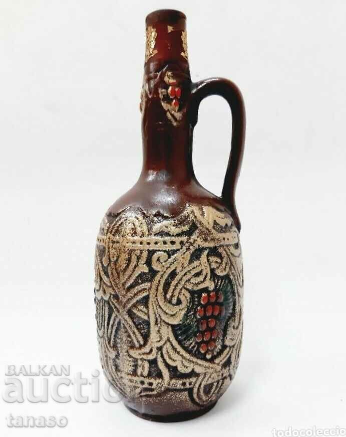 Auction Ornate ceramic pitcher (4.5) Auction Ornate ceramic pitcher (4.5)