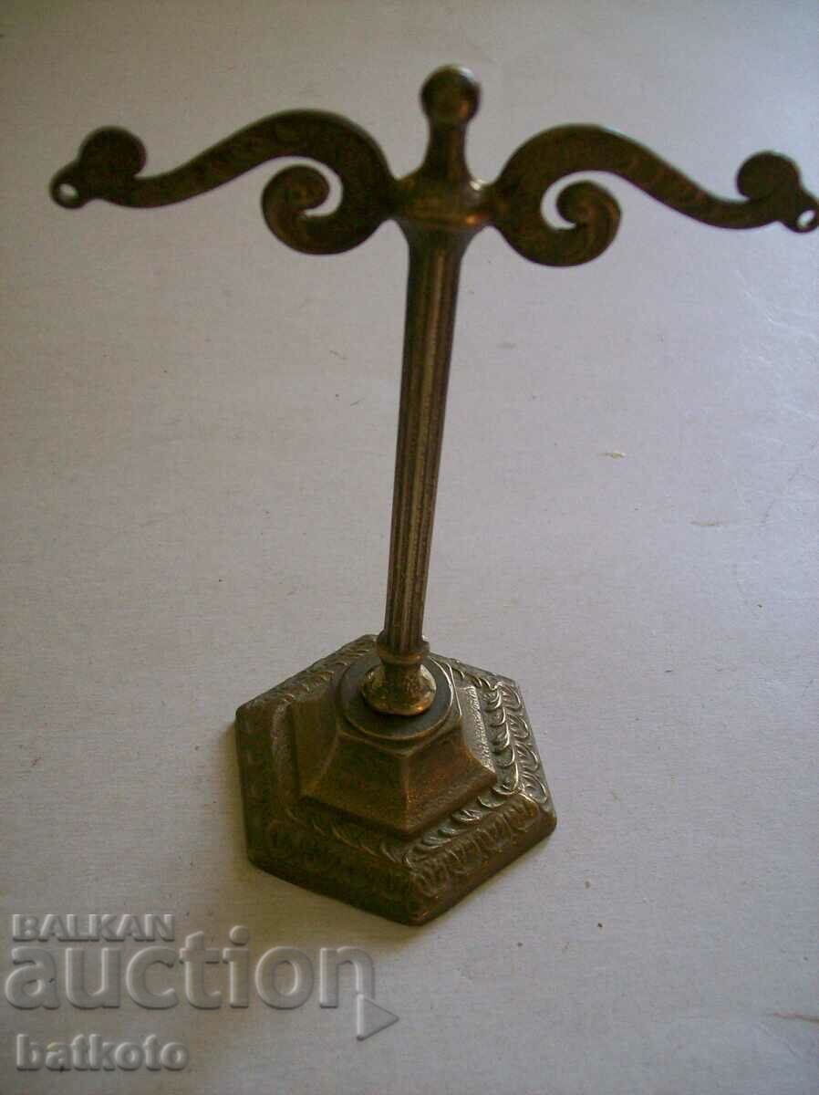 A very old brass watch stand