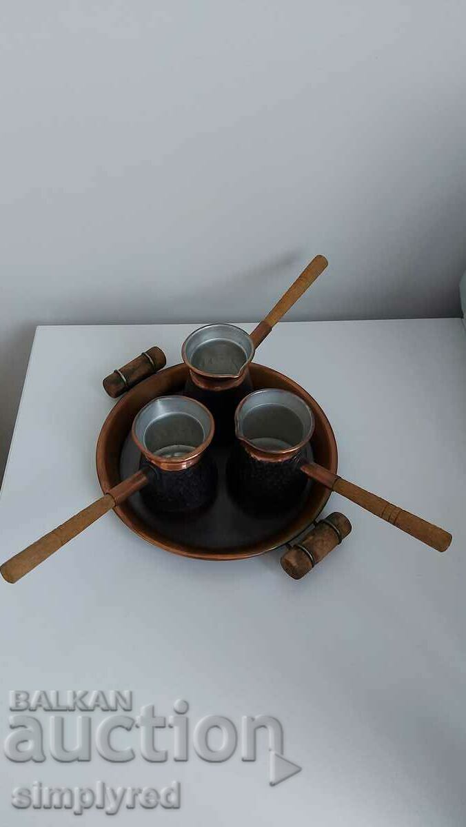 A set of special copper pots with a tray and wooden handles
