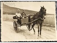 Old photo - two men with a horse and cart on a walk.