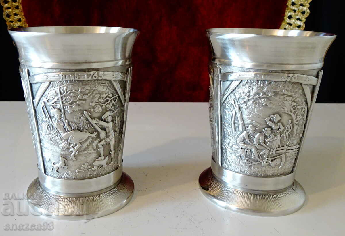 Two pewter wine goblets, three romantic paintings