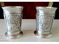 Two pewter cups with three romantic paintings.