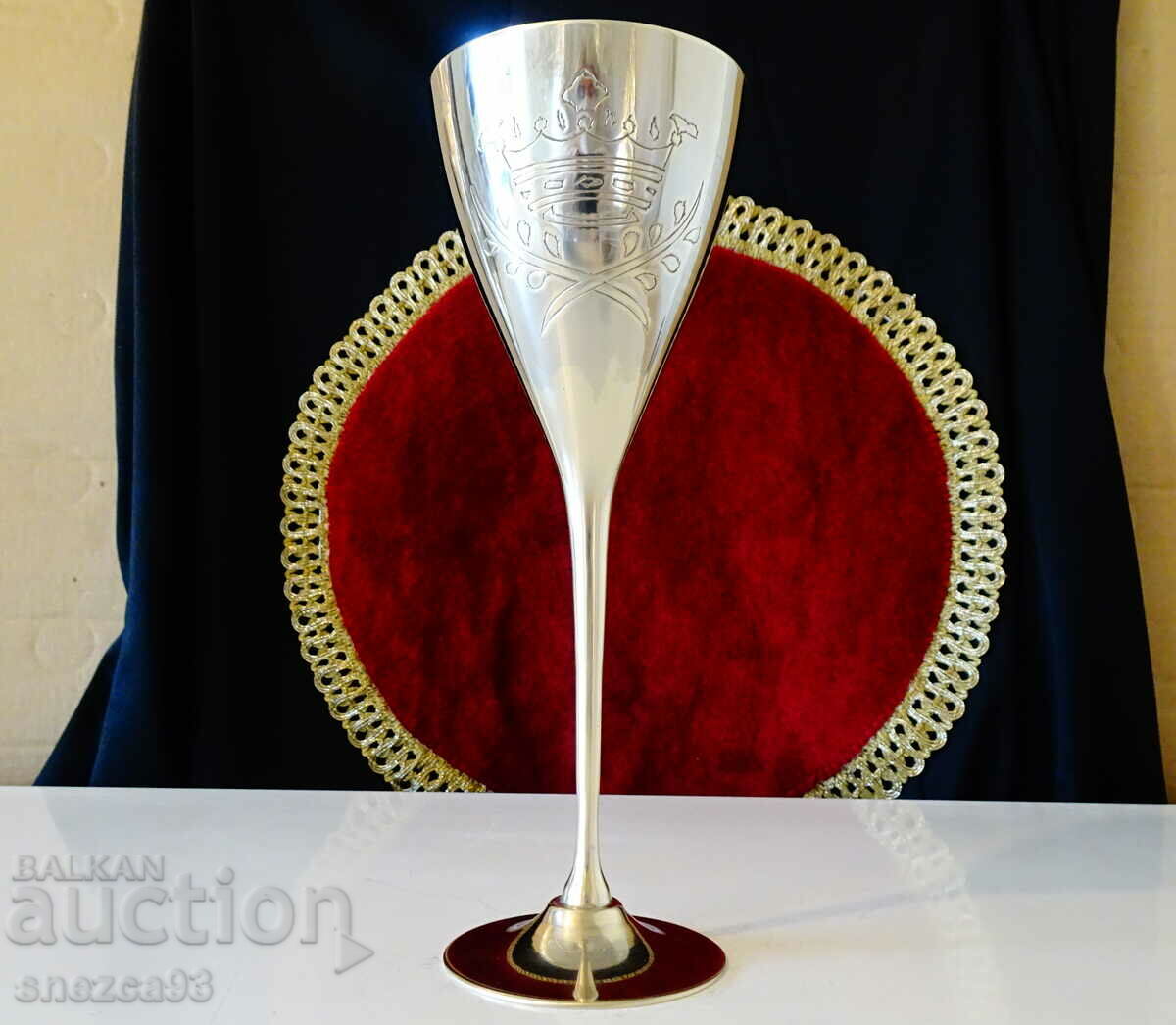 Bronze goblet with royal crown and laurel wreath.
