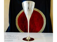 Bronze goblet with royal crown and laurel wreath.