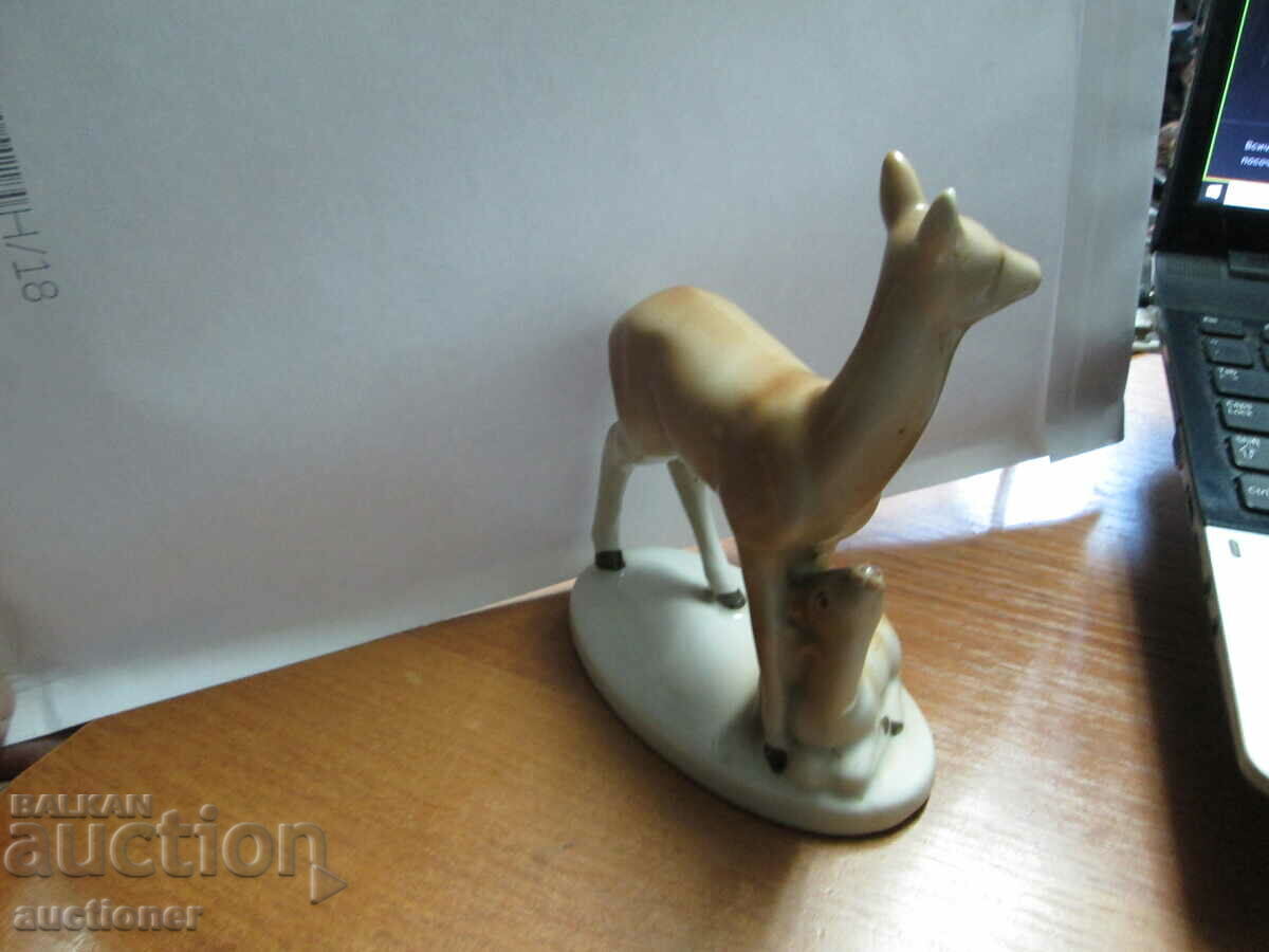 Delivery of AN OLD PORCELAIN FIGURE OF A DOE WITH HER LITTLE