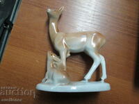 AN OLD PORCELAIN FIGURE OF A DOE WITH HER LITTLE