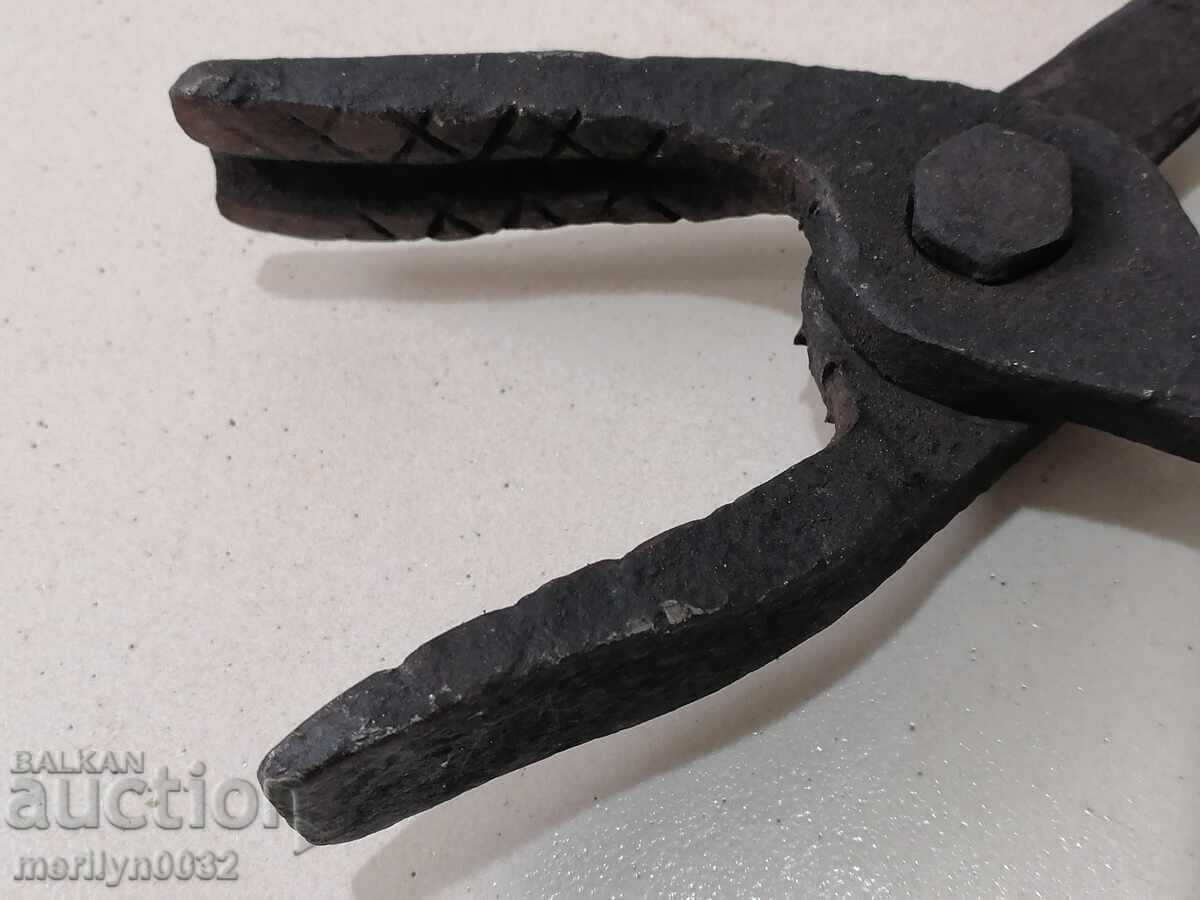 Delivery of Old blacksmith's tongs, wrought iron, tool Delivery of Old blacksmith's tongs, wrought iron, tool