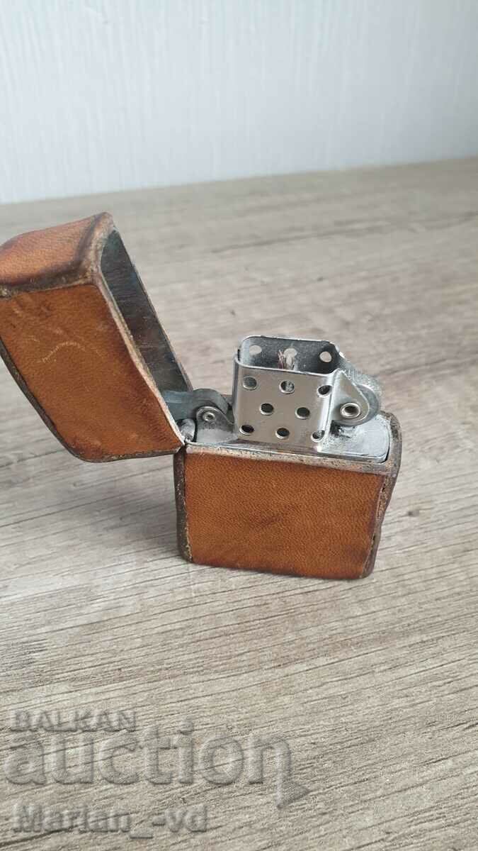 Old gasoline lighter lined with natural leather