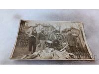 Photo Three men cutting firewood with a circular saw