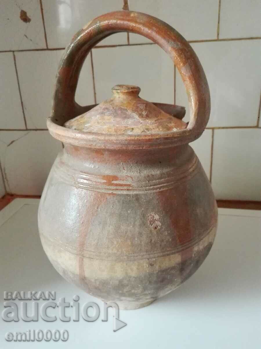 Old clay pot with lid.