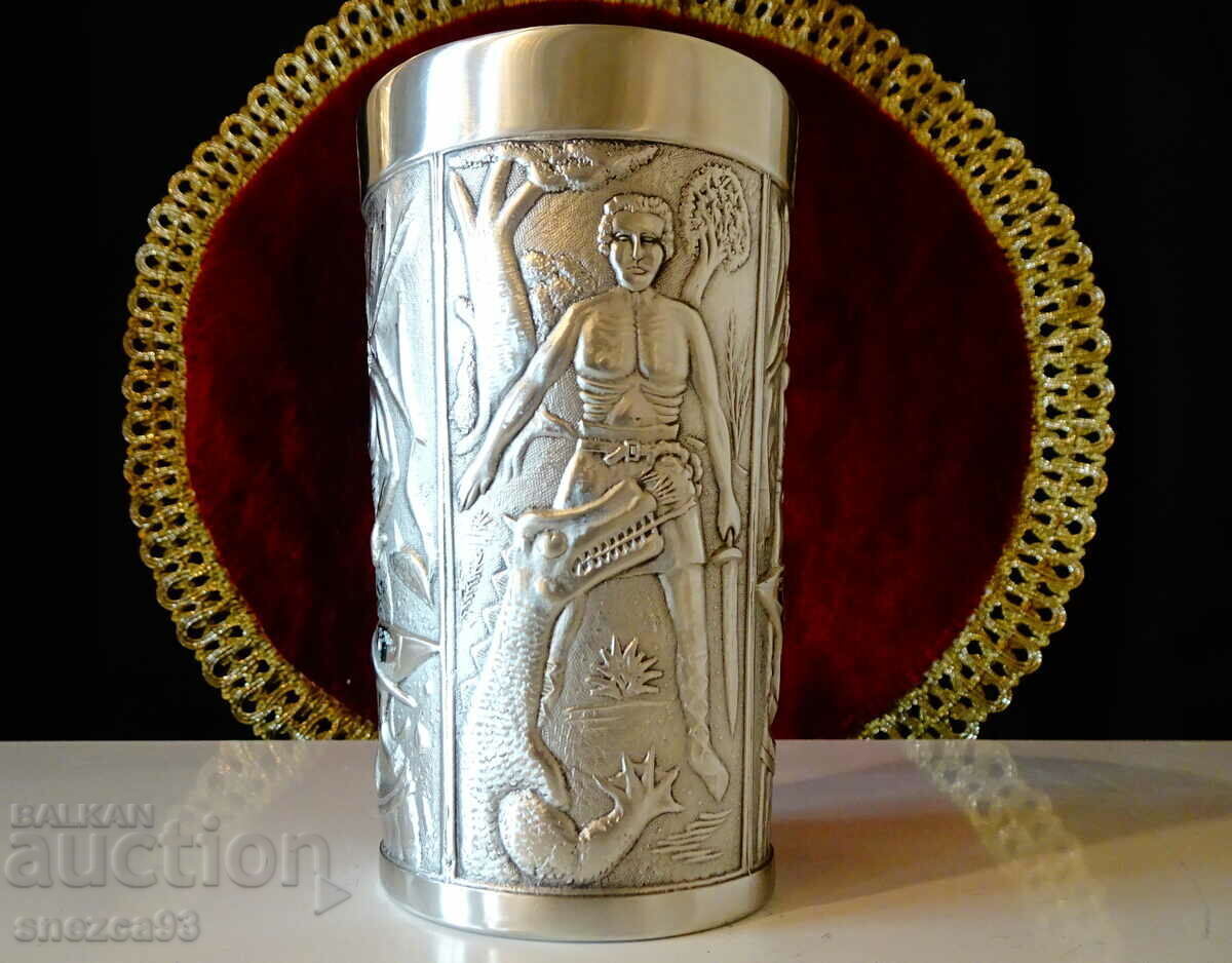 A mug, a pewter cup with a heroic blacksmith and a dragon. A mug, a pewter cup with a heroic blacksmith and a dragon.