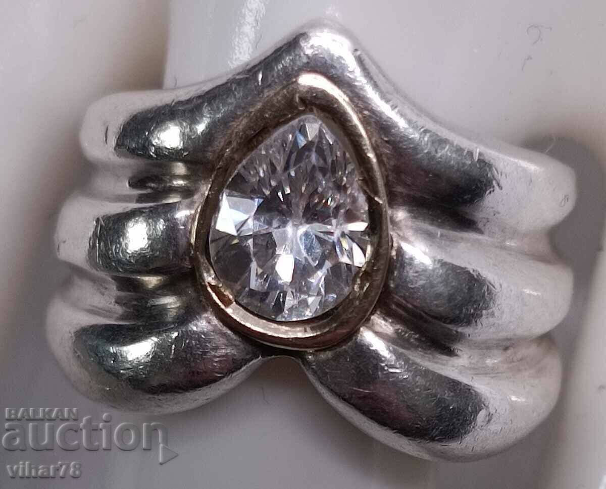 Auction A silver ring with a gold bracelet around the stone Auction A silver ring with a gold bracelet around the stone