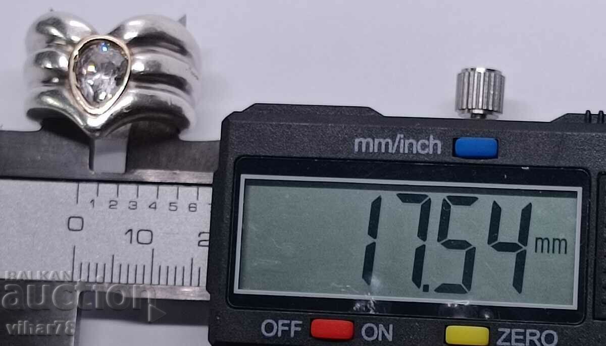 Delivery of A silver ring with a gold bracelet around the stone Delivery of A silver ring with a gold bracelet around the stone