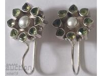 silver earrings with peridots and a pearl in the middle