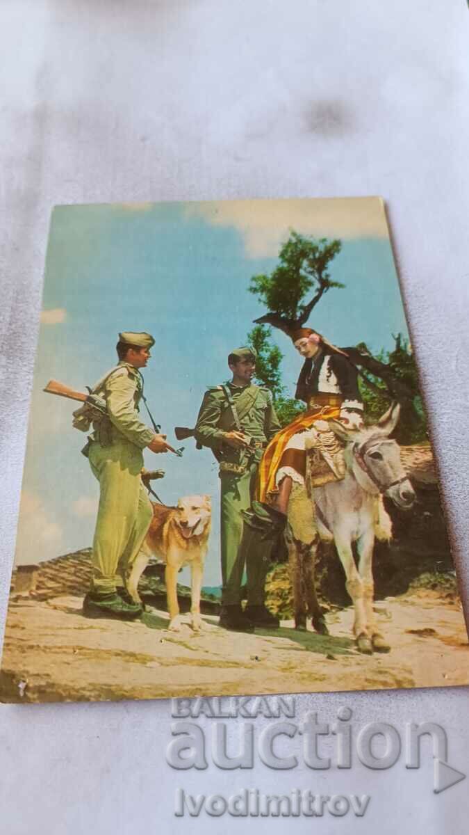P K Two border guards and a girl in folk costume on a donkey