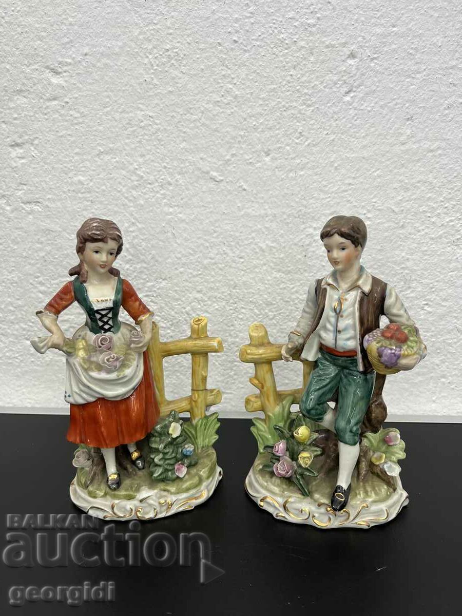 A pair of old German figures of a boy and a girl. #5176