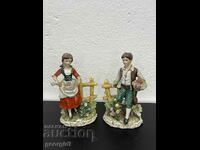 A pair of old German figures of a boy and a girl. #5176
