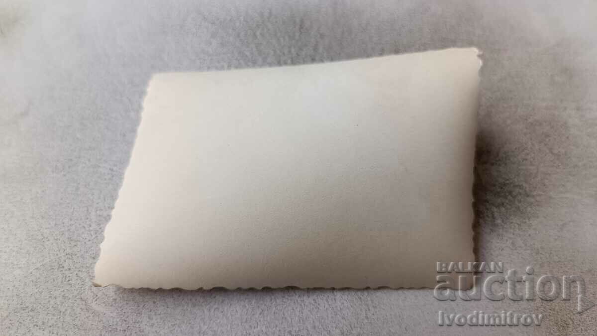 Photo Three men and a young woman on the beach with price 1.65 BGN | € 0.84