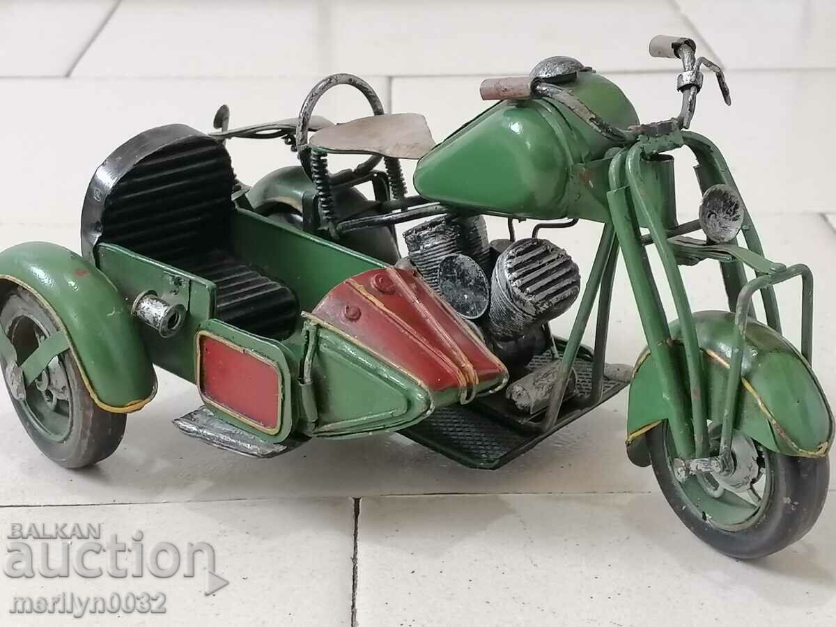 Children's tin toy motorcycle with a handmade basket