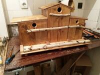 Handmade birdhouses on a platform with feeders