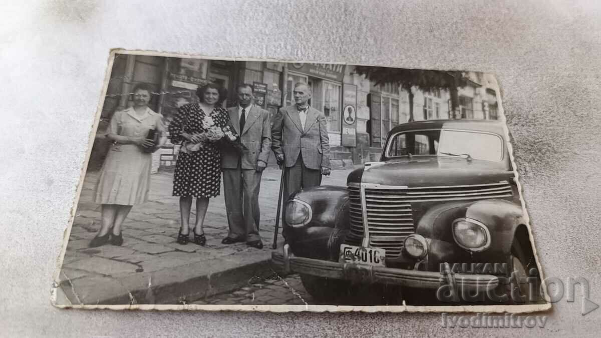 Photo Sofia Men and women on the sidewalk next to a vintage car 1947