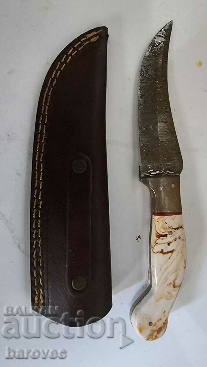 An old knife with a thread and a leather handle
