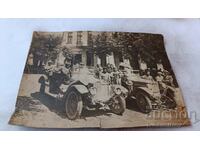 Photo Men, women and children with a vintage car. in front of Beer Hall Next