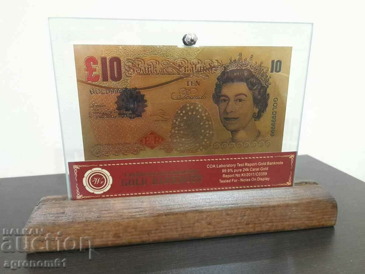 Auction Banknotes Pounds gold in a glass holder and solid wood Auction Banknotes Pounds gold in a glass holder and solid wood