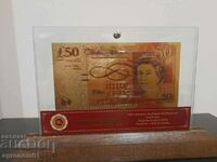 Banknotes Pounds gold in a glass holder and solid wood