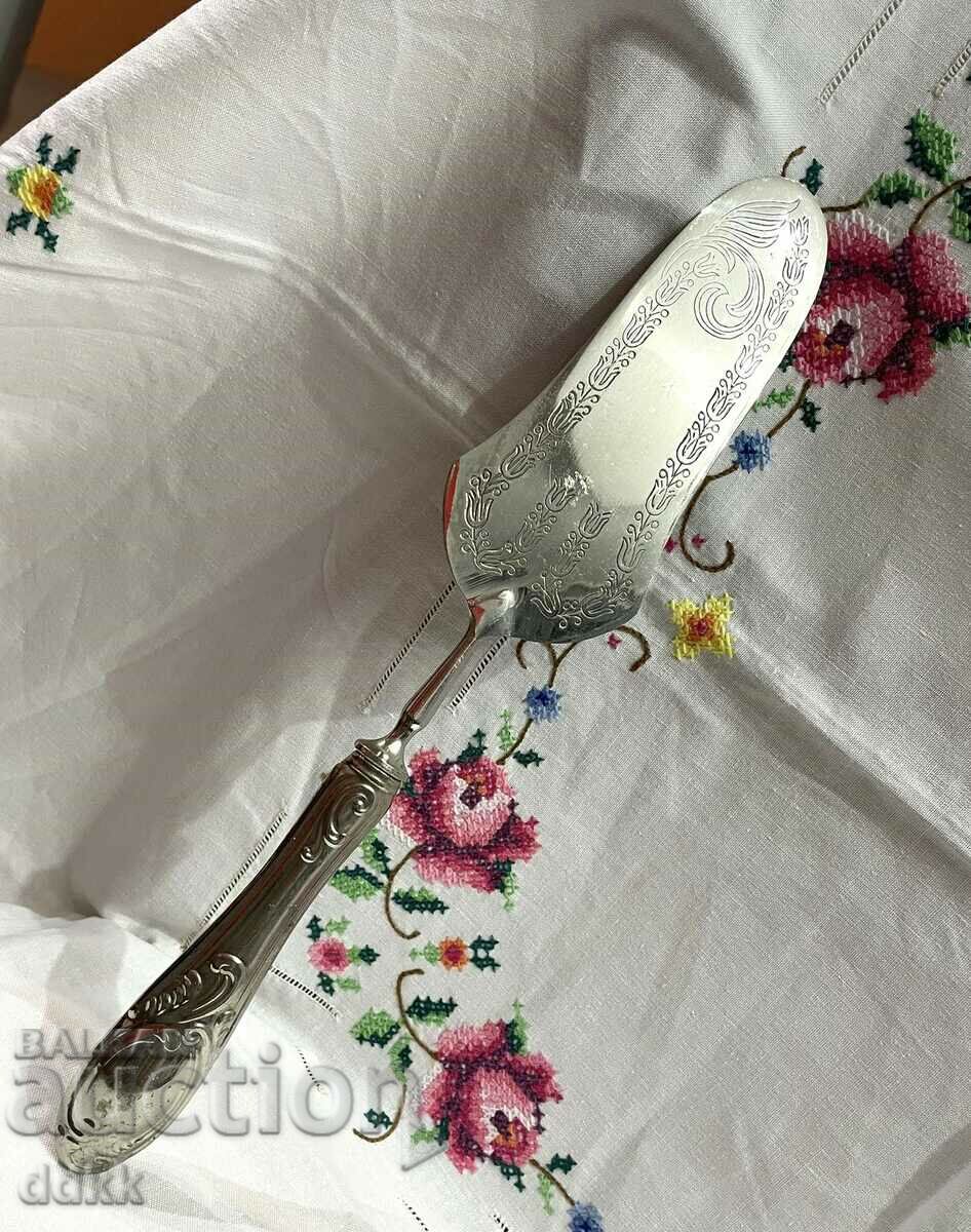 A beautiful spatula for serving a cake made of colored metal