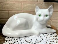 Large white porcelain cat with green eyes