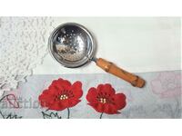 A beautiful strainer with a bamboo handle from England