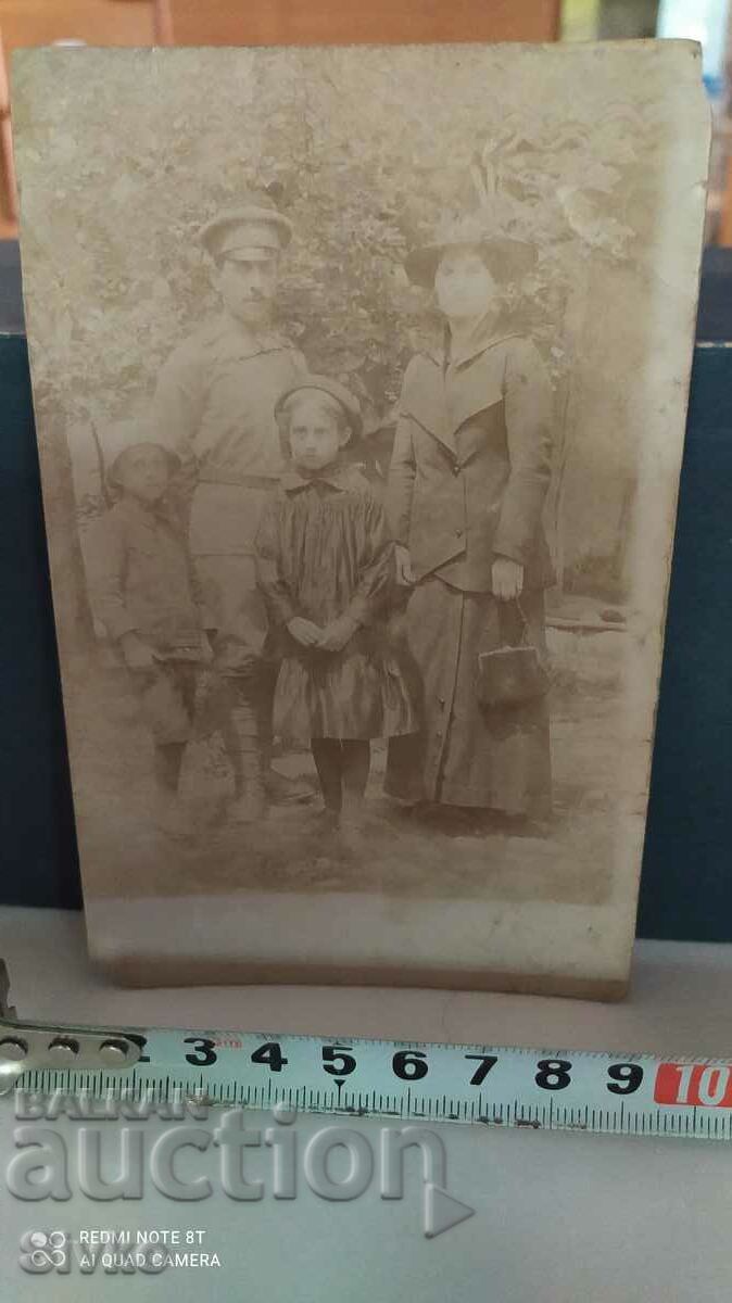 A card of an old military man with his family