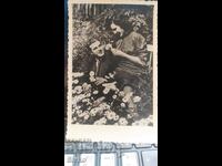 Card vintage youth in a flower garden