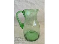 A beautiful little jug of green glass