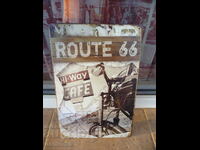 Metal sign motorcycle Route 66 cafe cafe on road horizon road