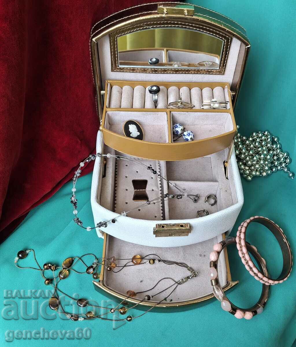A suitcase with various jewelry