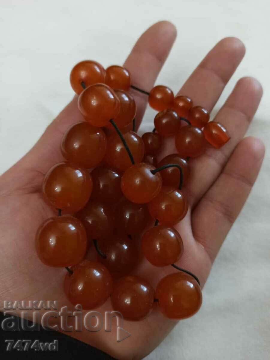 Auction  Old Russian amber necklace with round, solid beads and earrings