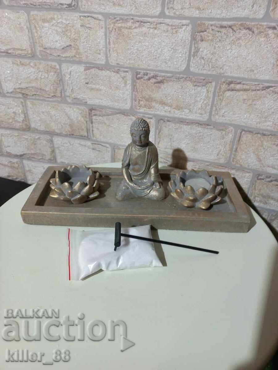 A set of Buddha candlesticks with sand